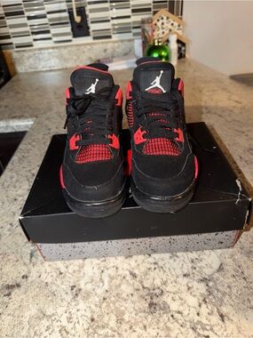 Nike Air Jordan 4 Retro sneakers in the "Red Thunder" colorway.